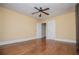 Bedroom showcasing hardwood floors, neutral walls, ceiling fan, and multiple closets at 8573 Campbellton St, Douglasville, GA 30134