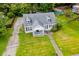 Aerial view of a charming home with mature trees and a well-manicured lawn at 8573 Campbellton St, Douglasville, GA 30134