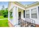 The front porch has white columns and a view of the well-kept lawn at 8573 Campbellton St, Douglasville, GA 30134