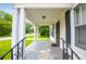 Charming covered front porch with black railings, offering curb appeal at 8573 Campbellton St, Douglasville, GA 30134