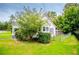 Home with a partially fenced yard and mature trees adding shade at 8573 Campbellton St, Douglasville, GA 30134