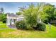 Home with an inviting front porch and partially fenced yard, surrounded by mature trees at 8573 Campbellton St, Douglasville, GA 30134