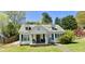 Charming home featuring a well-manicured lawn and a welcoming front porch perfect for relaxing outdoors at 8573 Campbellton St, Douglasville, GA 30134