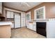 Efficient kitchen layout with white cabinets, appliances, and tile flooring at 8573 Campbellton St, Douglasville, GA 30134