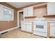 Charming kitchen featuring white appliances, tiled countertops, and ample cabinet space at 8573 Campbellton St, Douglasville, GA 30134