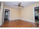 Inviting living room featuring hardwood floors, neutral walls, and vintage ceiling fan at 8573 Campbellton St, Douglasville, GA 30134