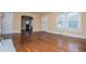 Living room with hardwood floors, neutral walls, white trim and many windows at 8573 Campbellton St, Douglasville, GA 30134