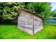 A rustic outbuilding adds character and extra storage space to this property with a well-kept lawn at 8573 Campbellton St, Douglasville, GA 30134