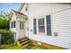 This home includes a convenient side entrance with stone steps leading to the door and classic window shutters at 8573 Campbellton St, Douglasville, GA 30134
