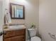 Cozy half bathroom with a vanity, framed mirror, towel rack, and neutral paint scheme at 879 Tranquil Way, Hampton, GA 30228