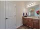 Bathroom featuring a single vanity, granite counters, wooden floors, and a linen closet at 879 Tranquil Way, Hampton, GA 30228