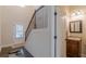 Inviting entryway with stairs, a half bathroom, tile floor, and a brightly lit entryway door at 879 Tranquil Way, Hampton, GA 30228