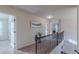 Hallway upstairs with iron railing and neutral tones offer an inviting transition to the bedrooms at 879 Tranquil Way, Hampton, GA 30228