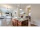 Open concept kitchen with an island, wood cabinets, and a view into the living room at 879 Tranquil Way, Hampton, GA 30228