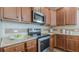 Modern kitchen featuring stainless steel appliances, granite countertops, and custom cabinetry at 879 Tranquil Way, Hampton, GA 30228