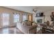 Bright living room with fireplace, plush sofas, large windows, and hardwood floors at 879 Tranquil Way, Hampton, GA 30228