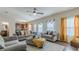 Bright and spacious living room with hardwood floors, large windows, and stylish furniture at 879 Tranquil Way, Hampton, GA 30228