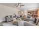 Open-concept living area with plush sofas, an ottoman, and seamless flow to the kitchen at 879 Tranquil Way, Hampton, GA 30228
