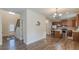Spacious open area featuring wood floors, a staircase, and a view of the kitchen at 879 Tranquil Way, Hampton, GA 30228
