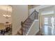 Carpeted staircase with wrought iron balusters, connecting the home's floors at 879 Tranquil Way, Hampton, GA 30228
