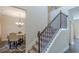Elegant staircase with carpeted steps, and wood railings at 879 Tranquil Way, Hampton, GA 30228