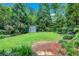Picturesque backyard with a storage shed surrounded by a lush lawn at 935 Cumberland Ne Rd, Atlanta, GA 30306