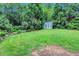Well-maintained backyard with a storage shed and lush greenery for privacy at 935 Cumberland Ne Rd, Atlanta, GA 30306