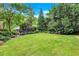 Expansive backyard featuring a lush green lawn and mature trees providing ample shade and privacy at 935 Cumberland Ne Rd, Atlanta, GA 30306