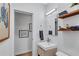 Clean, bright bathroom featuring modern fixtures, floating shelves, and stylish decor at 935 Cumberland Ne Rd, Atlanta, GA 30306