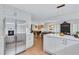 Open-concept kitchen boasts white cabinets, stainless steel refrigerator, and seamless flow to dining and living areas at 935 Cumberland Ne Rd, Atlanta, GA 30306