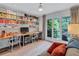 Well-lit office featuring a spacious desk, built-in shelving, and a serene view of the outdoors at 935 Cumberland Ne Rd, Atlanta, GA 30306