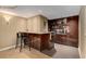 Finished basement wet bar featuring modern cabinetry, sleek countertops, and barstool seating at 2375 Hyde Park Nw Ct, Atlanta, GA 30318