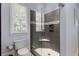 Modern bathroom featuring a glass enclosed shower with gray tiling, built in shelf, and mosaic accent at 2375 Hyde Park Nw Ct, Atlanta, GA 30318