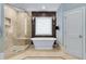 Bathroom featuring freestanding tub, glass shower, and decorative tile at 2375 Hyde Park Nw Ct, Atlanta, GA 30318