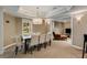 Basement dining area with seating for eight adjacent to comfortable basement living area at 2375 Hyde Park Nw Ct, Atlanta, GA 30318