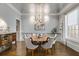 Bright dining room featuring hardwood floors, stylish chandelier, and large windows at 2375 Hyde Park Nw Ct, Atlanta, GA 30318