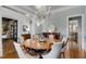 Spacious dining room with elegant chandelier, hardwood floors, and ample natural light at 2375 Hyde Park Nw Ct, Atlanta, GA 30318