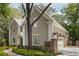 View of home's exterior with detailed trim, attached garage, and brick-lined walkway at 2375 Hyde Park Nw Ct, Atlanta, GA 30318