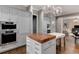 Contemporary kitchen design with butcher block island and views of the living room at 2375 Hyde Park Nw Ct, Atlanta, GA 30318