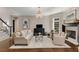 Elegant living room with a fireplace, plush seating, and hardwood floors at 2375 Hyde Park Nw Ct, Atlanta, GA 30318