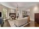 Cozy living room features a fireplace, hardwood floors, and comfortable seating under an elegant chandelier at 2375 Hyde Park Nw Ct, Atlanta, GA 30318