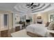 Spacious primary bedroom boasts tray ceilings, a fireplace, sitting area, and hardwood floors at 2375 Hyde Park Nw Ct, Atlanta, GA 30318