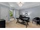 Bright office space with a decorative chandelier, a window seat, and a large desk at 2375 Hyde Park Nw Ct, Atlanta, GA 30318