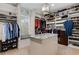 Large walk-in closet with center island and custom shelving for ample storage at 2375 Hyde Park Nw Ct, Atlanta, GA 30318