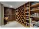 Custom wine cellar with wooden racks and shelving for ample bottle and glassware storage at 2375 Hyde Park Nw Ct, Atlanta, GA 30318