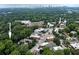 An aerial view showcases mature trees, nearby shopping, and the city skyline in the distance at 2023 Oakview Se Rd # 226, Atlanta, GA 30317