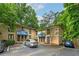Exterior view of brick apartment complex, parking lot, and shade trees at 2023 Oakview Se Rd # 226, Atlanta, GA 30317