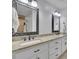 Elegant bathroom featuring double sinks, granite countertops, and large mirrors at 2095 Honeysuckle Dr, Cumming, GA 30040