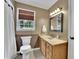Bathroom with wood paneled walls, modern vanity, wood blinds and white bath fixtures at 2095 Honeysuckle Dr, Cumming, GA 30040