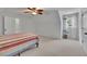 Bright bedroom featuring carpet floors, a ceiling fan, and a window with sheer curtains at 2095 Honeysuckle Dr, Cumming, GA 30040